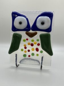 a rectangular owl made out of fused glass