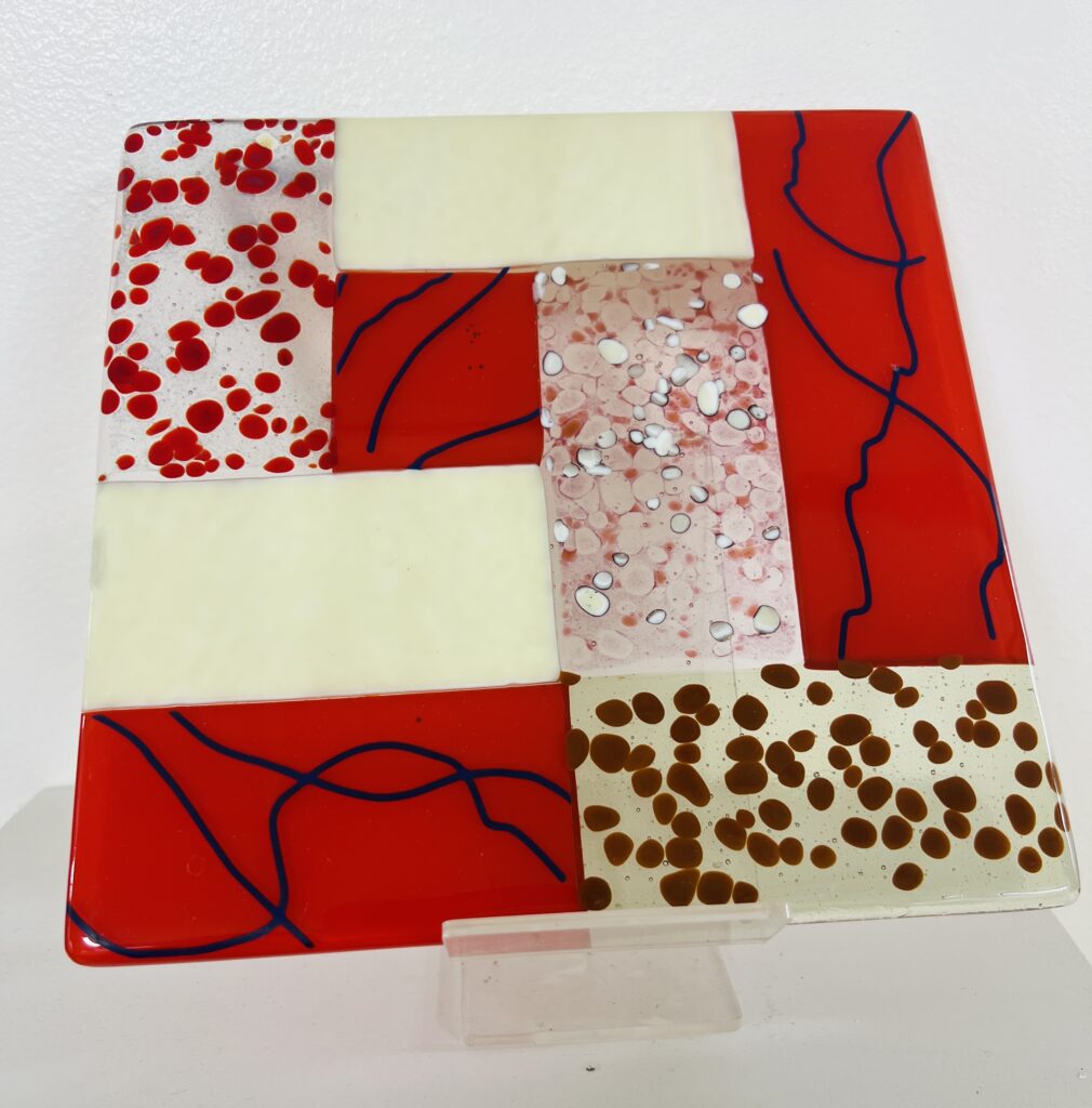 A photograph of a square piece of fused glass artwork